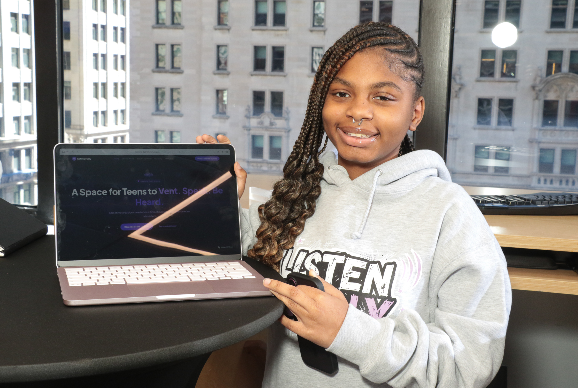 The Listen Loudly founder presenting her venture website on a laptop at an OITF event