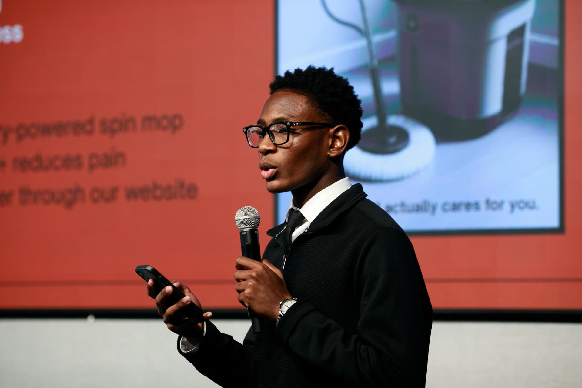 A young entrepreneur presenting a business idea to a real audience