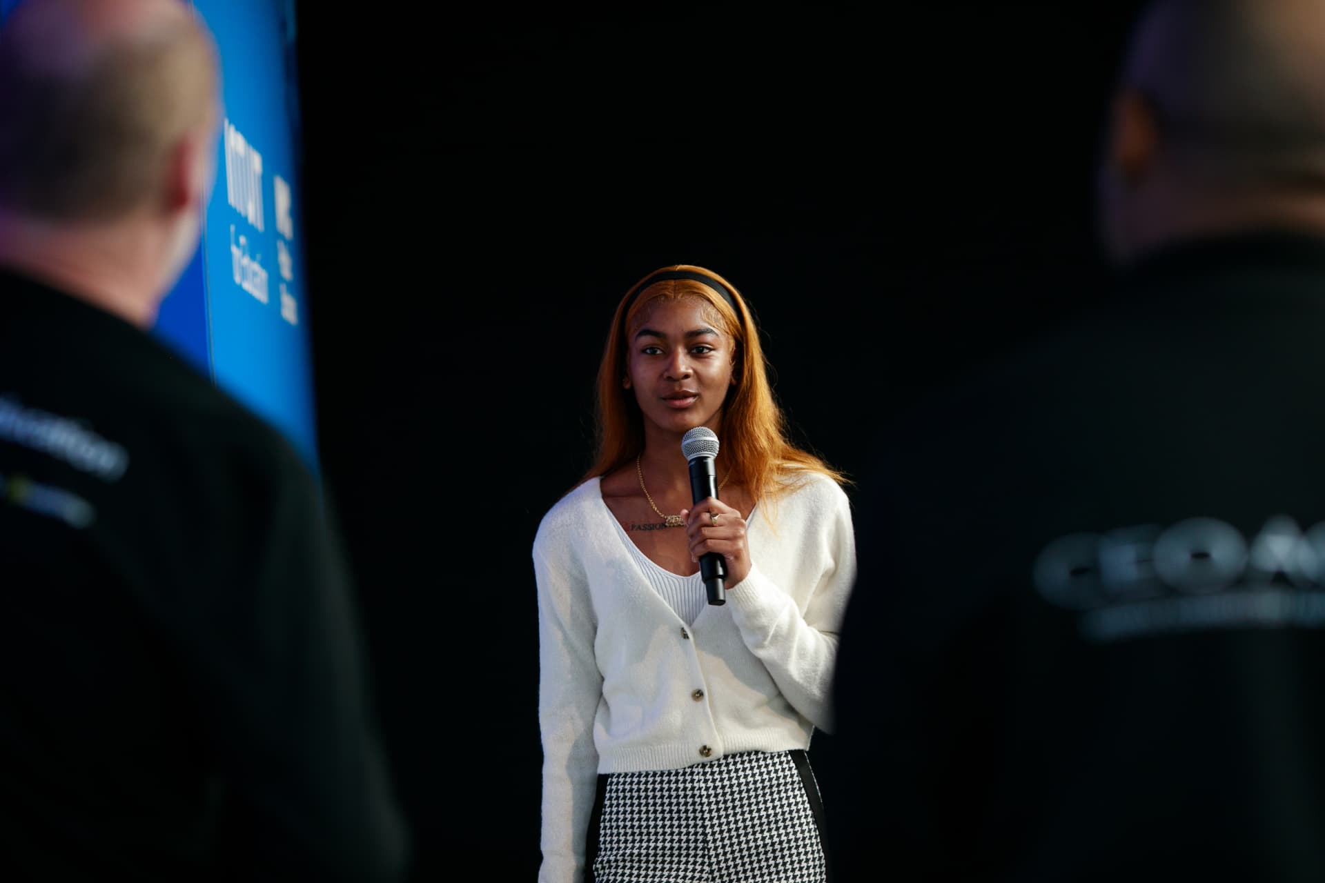 A student founder presenting a venture to an audience at an OITF event